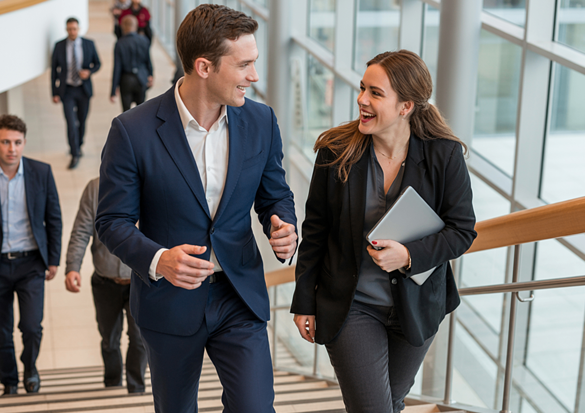 Two professionals in business attire walking through a modern office